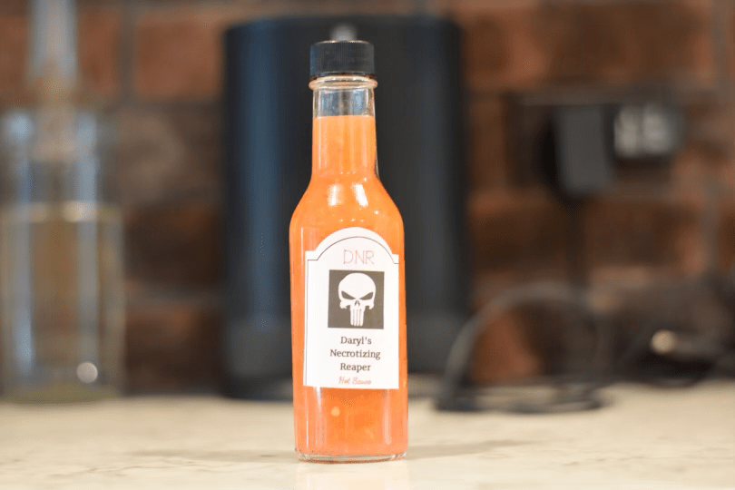 DNR Hot Sauce bottles with fresh peppers